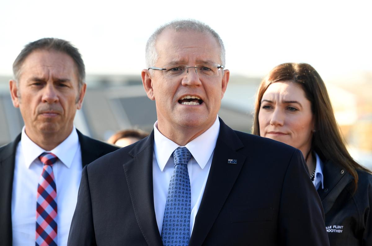 Australian Prime Minister Scott Morrison speaks to media with Federal Member for Boothby Nicolle Flint (R) at a building site in Oaklands Park, the seat of Boothby on May 14, 2019 in Adelaide, Australia. (Tracey Nearmy/Getty Images)