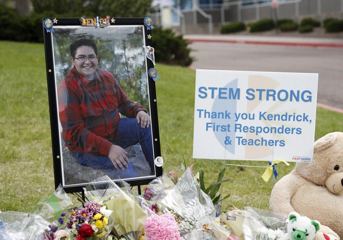 A photograph of student Kendrick Castillo stands amid a display of tributes outside the STEM School Highlands Ranch a week after the attack on the school that left Castillo dead and others injured in Highlands Ranch, Colo., on May 14, 2019. (David Zalubowski/AP Photo)