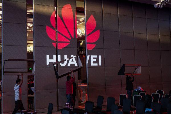 Workers prepare the venue for a Huawei summit on April 16, 2019, in Shenzhen, China. (Billy H.C. Kwok/Getty Images)