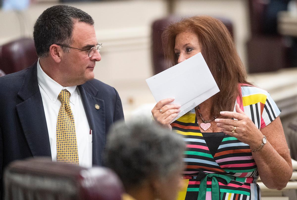 Rep. Terri Collins (R) chats with Rep. Chris Pringle on the house floor at the Alabama Statehouse in Montgomery, Ala., on May 14, 2019. (Mickey Welsh/Montgomery Advertiser via AP)