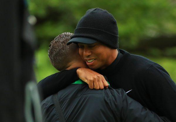 Tiger Woods embraces golf instructor Sean Foley during a practice round prior to the 2019 PGA Championship at the Bethpage Black course in Bethpage, N.Y., on May 14, 2019. (Mike Ehrmann/Getty Images)