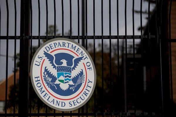 The U.S. Department of Homeland Security (DHS) seal hangs on a fence at the agency's headquarters in Washington on Dec. 11, 2014. (Andrew Harrer/Bloomberg via Getty Images)