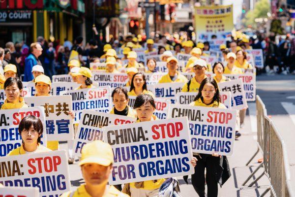 Falun Dafa practitioners raise awareness about forced organ harvesting atrocities in China, as they march through Manhattan during World Falun Dafa Day, on May 16, 2019. (Edward Dye/The Epoch Times)