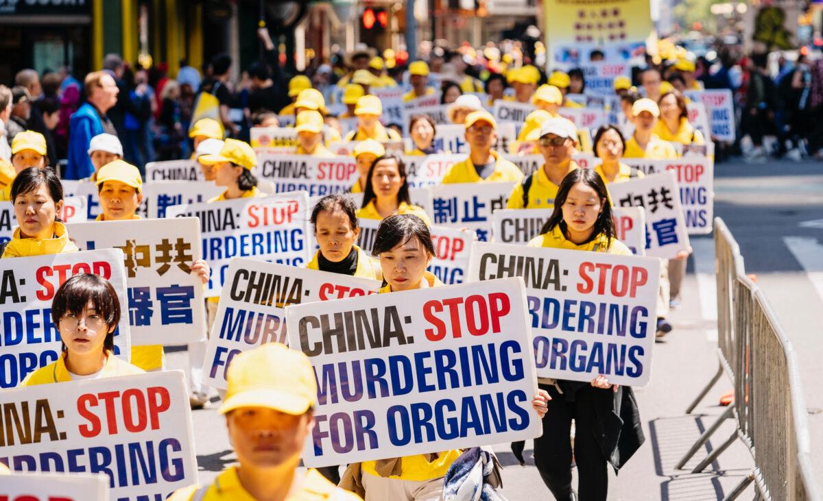 Falun Dafa practitioners raise awareness about forced organ harvesting atrocities in China, as they march through Manhattan celebrating World Falun Dafa Day, on May 16, 2019. (Edward Dye/The Epoch Times)