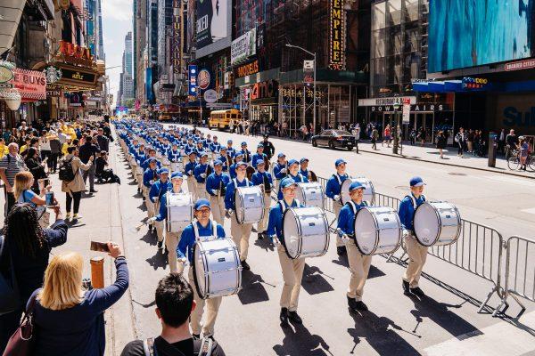 The Tian Guo Marching Band, consisting of Falun Dafa practitioners, march through Times Square in New York on May 16, 2019. (Edward Dye/The Epoch Times)
