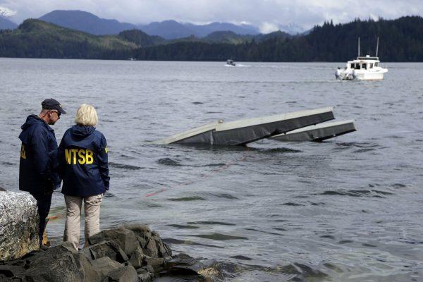 National Transportation Safety Board, NTSB investigator Clint Crookshanks, left, and member Jennifer Homendy stand near the site of some of the wreckage of the DHC-2 Beaver near Ketchikan, Alaska on May 15, 2019. (Peter Knudson/NTSB via AP)