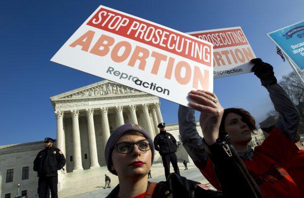 Abortion rights activists protest outside of the U.S. Supreme Court, during the March for Life in Washington. The passage of abortion restrictions in Republican-led states and a corresponding push to buttress abortion rights where Democrats are in power stem from the same place: Changes in the composition of the high court. (Jose Luis Magana/AP)