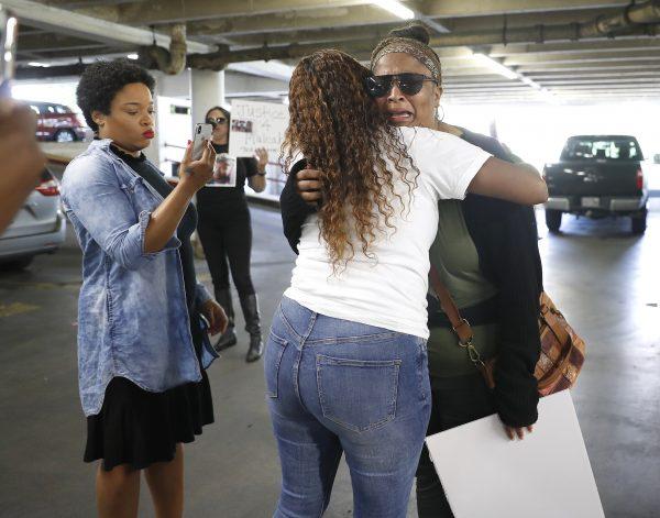 Brittany Bowens, facing camera, the mother of the missing 4-year-old Maleah Davis is hugged by Taneshia Brown in Houston, on May 13, 2019. (Karen Warren/Houston Chronicle via AP)