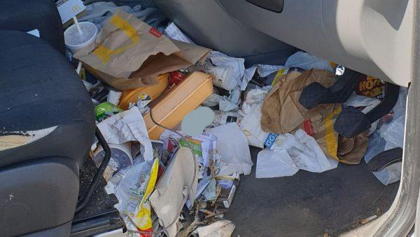 McDonald’s wrappers and cups, Styrofoam containers, pieces of paper, documents, and various other pieces of garbage can be seen pouring out of the driver’s side cab, on the dash, and behind the pedals. (Thames Valley Police Department)