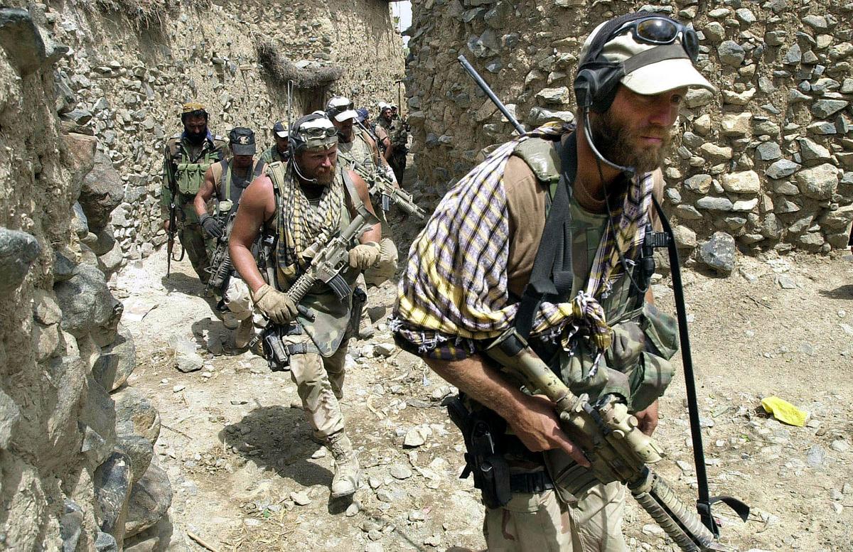A-Team Special Forces Group walks through a village on Aug. 22, 2002, in Narizah, 140 km (86 miles) east of Kabul, Afghanistan. U.S. Special Forces were first to enter villages in Southeastern Afghanistan during Operation Mountain Sweep. More than 2,000 troops took part in the operation. (Wally Santana-Pool/Getty Images)