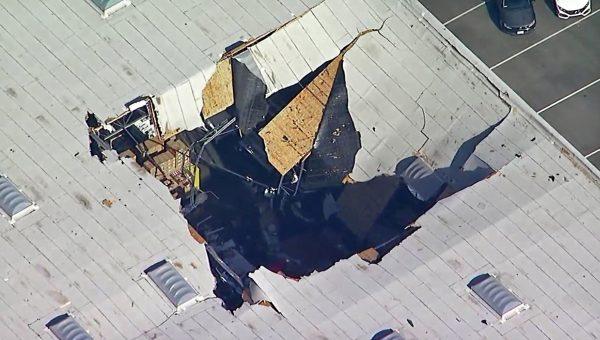An F-16 fighter jet crashed into a warehouse just outside March Air Reserve Base in Riverside, Calif., on May 16, 2019. (KABC-TV via AP)