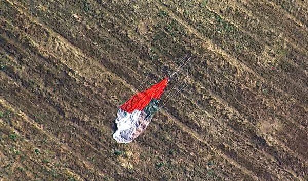 The parachute left by the pilot who ejected before his F-16 fighter jet crashed into a warehouse just outside March Air Reserve Base in Riverside, Calif., on May 16, 2019. (KABC-TV via AP)