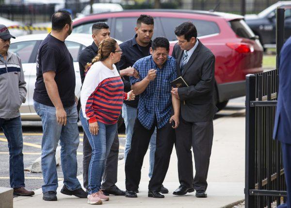 Arnulfo Ochoa, the father of Marlen Ochoa-Lopez, is surrounded by family members and supporters, as he walks into the Cook County medical examiner's office to identify his daughter's body, in Chicago, Ill., on May 16, 2019. (Ashlee Rezin/Chicago Sun-Times via AP)