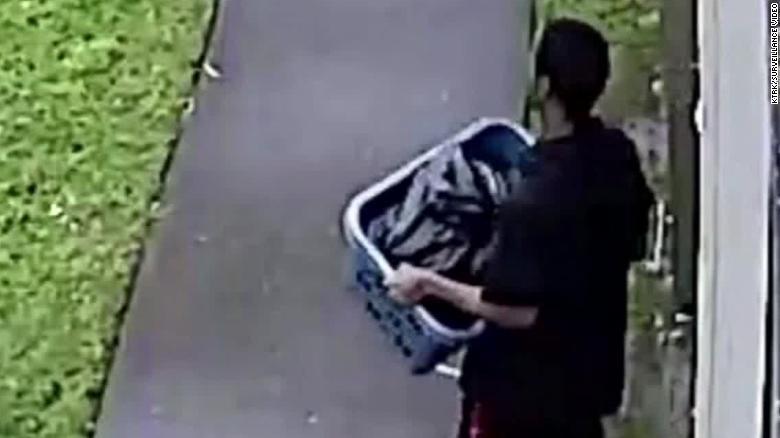 Surveillance footage captured Derion Vence walking out of his apartment with a blue laundry basket. Vence was later arrested for tampering with evidence. (CNN)