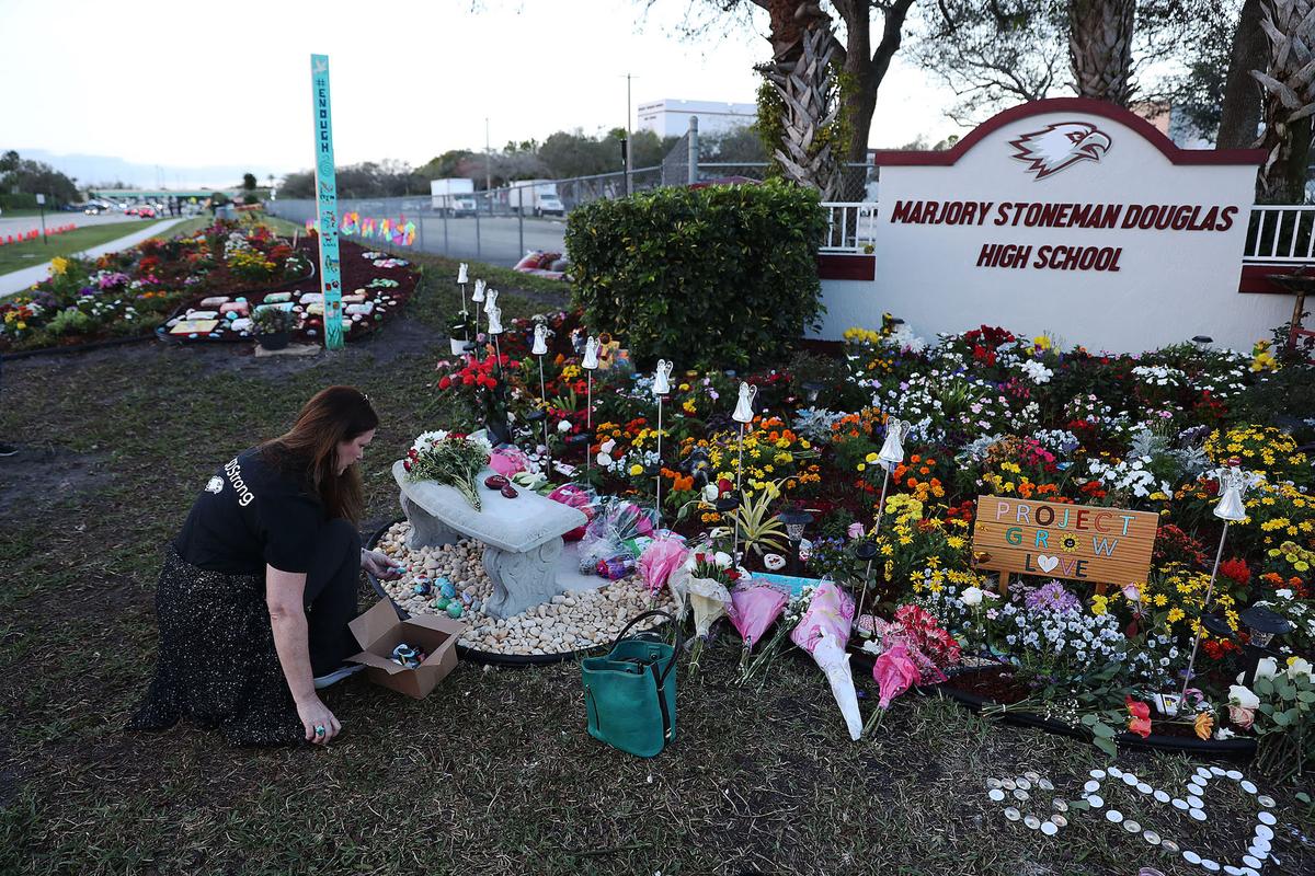 A woman visits a memorial setup at Marjory Stoneman Douglas High School in Parkland, Florida, on Feb. 14, 2019. 14 students and three staff members were killed during the mass shooting at Marjory Stoneman Douglas High School on Feb. 14, 2018. (Joe Raedle/Getty Images)