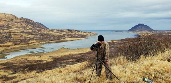 Viacheslav Akimenko using a spotting scope at Sturgeon Lagoon near Kodiak, Alaska, shortly before he died in May 2019. (Aleksandr Neverov via AP)