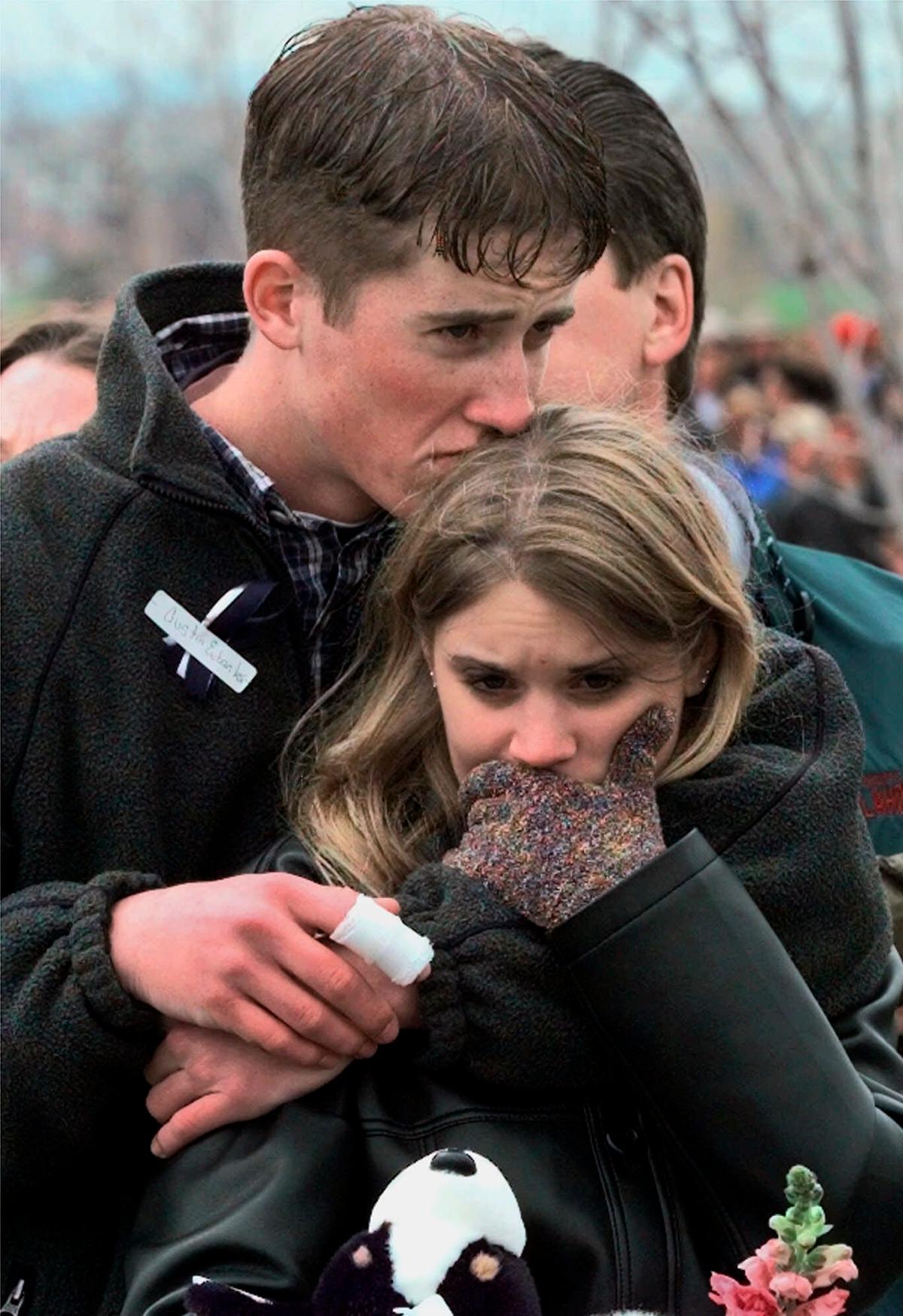 Austin Eubanks hugs his girlfriend during a community-wide memorial service in Littleton, Colo., for the victims of the shooting rampage at Columbine High School on April 25, 1999. (Bebeto Matthews/AP Photo)