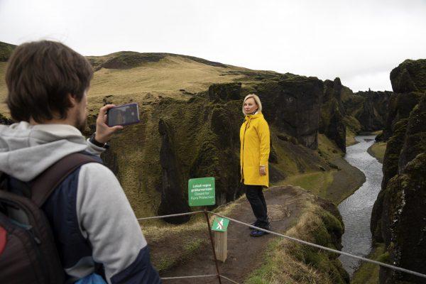 Russian tourist Nadia Kazachenok poses for a photograph taken by Mikhail Samarin at the Fjadrárgljúfur in Iceland on May 1, 2019. (Egill Bjarnason/File Photo via AP)
