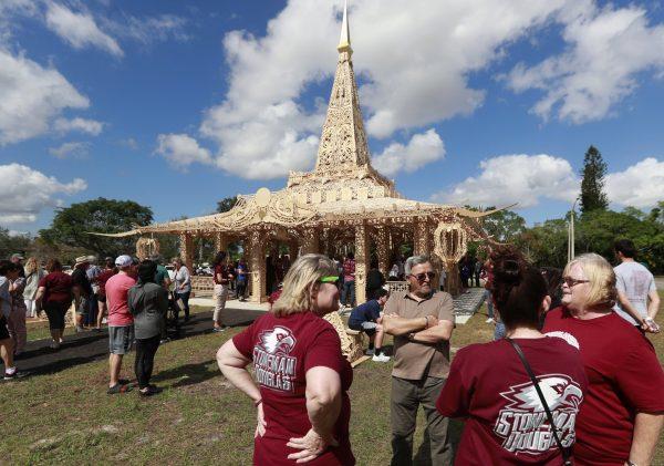 People gather around the "Temple of Time" on Feb. 14, 2019, in honor of the 17 that were killed during the Marjory Stoneman Douglas High School shooting in 2018 in Coral Springs, Fla. (Wilfredo Lee/File photo via AP)