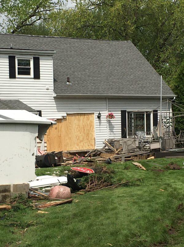 A board covers the hole where the pickup truck hit the house in Spring Grove, Lake County, Illinois (Lake County Sheriff's Office)