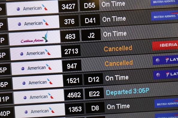 A sign at the Miami International Airport shows canceled flights as American Airlines grounds it Boeing 737 Max 8 planes in Miami, Fla., on March 13, 2019. (Joe Raedle/Getty Images)