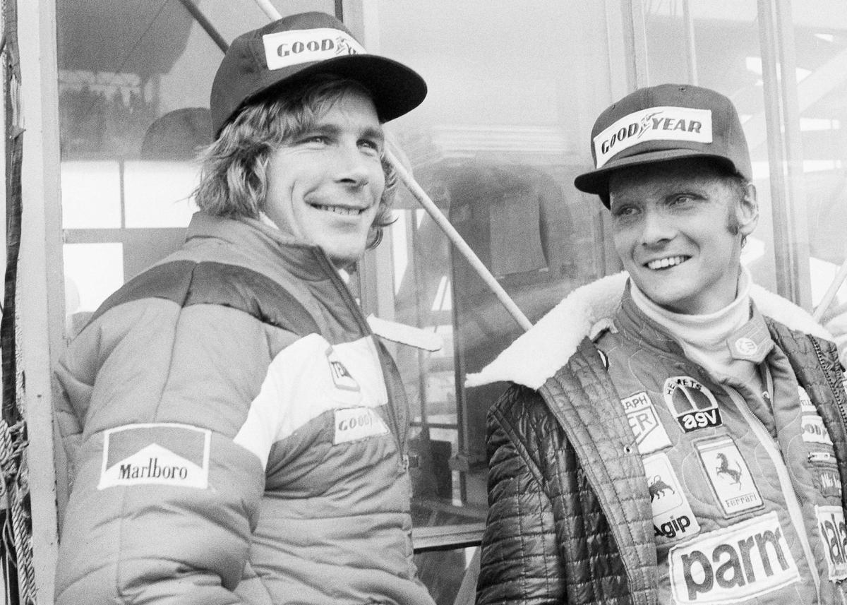 Austrian auto racer Niki Lauda, right, defending champion in world driving, and James Hunt, of Britain, look at the rain before the start of the Japan Grand Prix Formula One auto race at Fuji International Speedway, Gotemba, Japan, on Oct. 24, 1976. (AP Photo/Nick Ut, File)