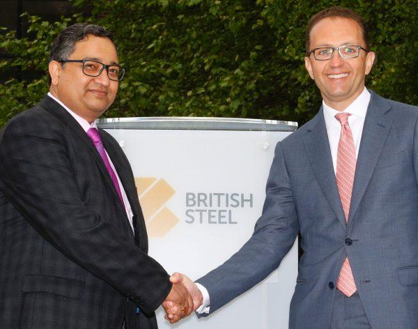 Managing partner of Greybull Capital Marc Meyohas (R) shakes hands with Bimlendra Jha, chief executive of Tata Steel UK (L), at the newly-branded British Steel steelworks plant in Scunthorpe on June 1, 2016. (Lindsey Parnaby/AFP/Getty Images)