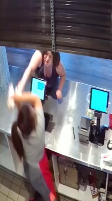 The woman is pictured apparently striking the staff member with a sandwich bag in the unnamed restaurant in Kennewick, Washington, on May 19, 2019. (Kennewick Police)