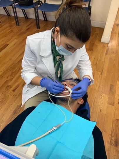 Dr. Shenjuti Chowdhury working on a patient in Astoria, New York. (Joanna Wisniewska)