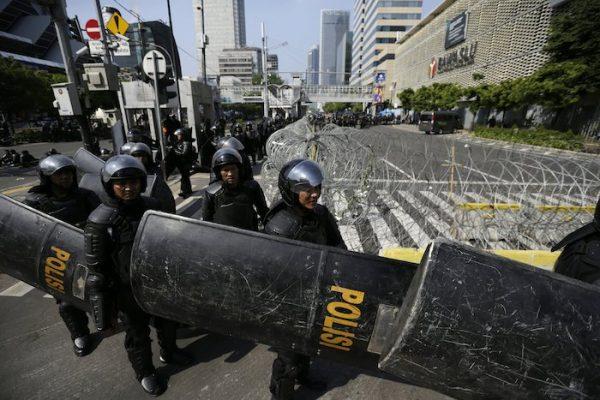 Riot police officers take their position outside the building that house the Election Supervision Board in Jakarta, Indonesia, on May 22, 2019. (Dita Alangkara/AP Photo)