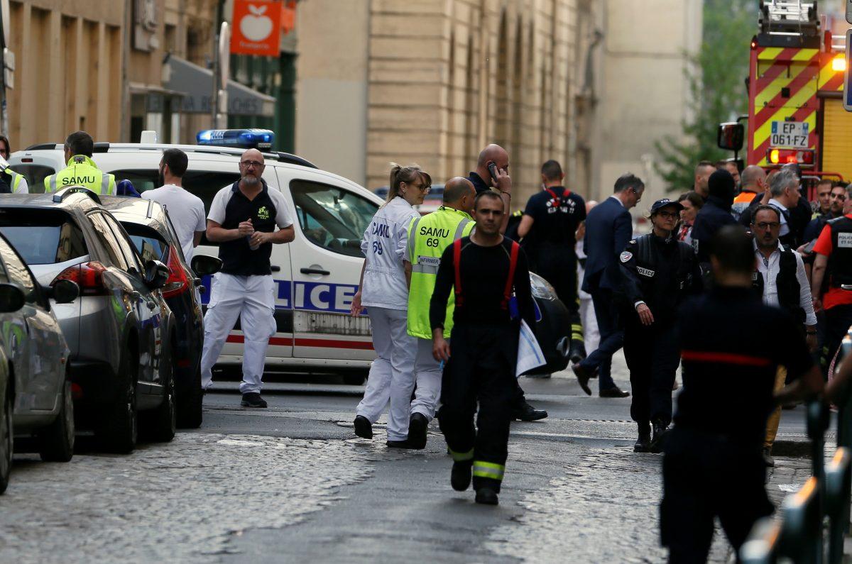 Police officers, fire fighters and medics are seen near the site of a suspected bomb attack in central Lyon, France, on May 24, 2019. (Emmanuel Foudrot/Reuters)