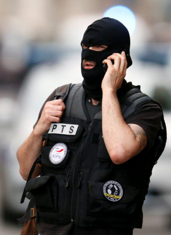 A police officer on the phone near the site of a suspected bomb attack in central Lyon, France, on May 24, 2019. (Emmanuel Foudrot/Reuters)