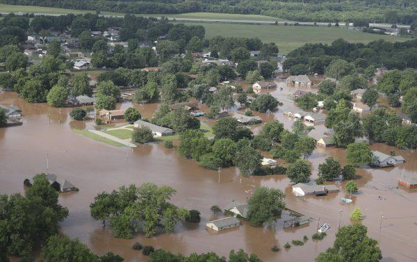 Homes are flooded near South 145th West Ave. near Oklahoma 51 on the Arkansas River in Tulsa, Okla., on Friday, May 24, 2019. (Tom Gilbert/Tulsa World via AP)