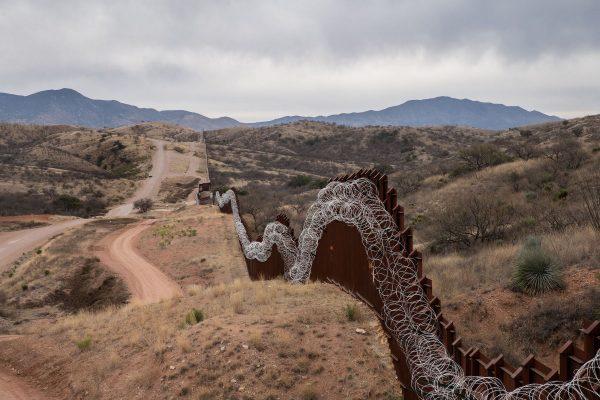 A general view of the US border fence, covered in concertina wire, separating the US and Mexico, at the outskirts of Nogales, Arizona, on Feb. 9, 2019. (Ariana Drehsler/AFP/Getty Images)