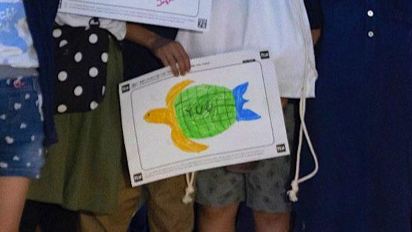 A Japanese boy at the digital aquarium drew a green turtle with yellow feet. (Koji Sasahara/AP)