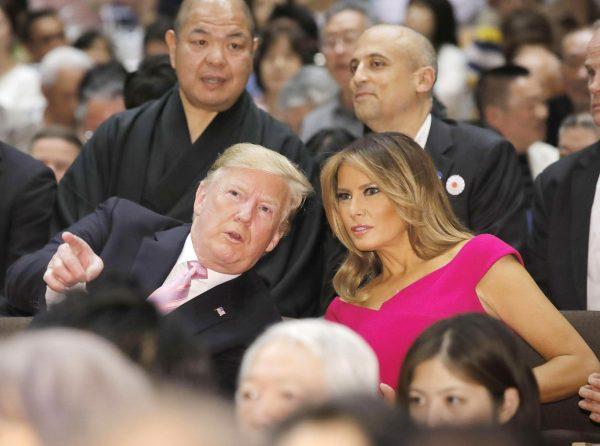 President Donald Trump, left, and First Lady Melania Trump, right, chat during an annual summer sumo wrestling championship in Tokyo, Japan on May 26, 2019. (Daiki Katagiri/Kyodo News via AP)