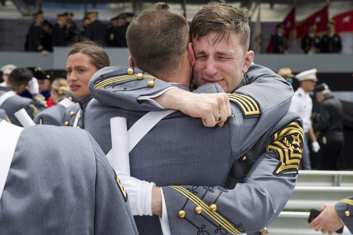 West Point cadets hug each other at the end of graduation ceremonies at the United States Military Academy, in West Point, N.Y., on May 25, 2019. (Julius Constantine Motal/AP Photo)