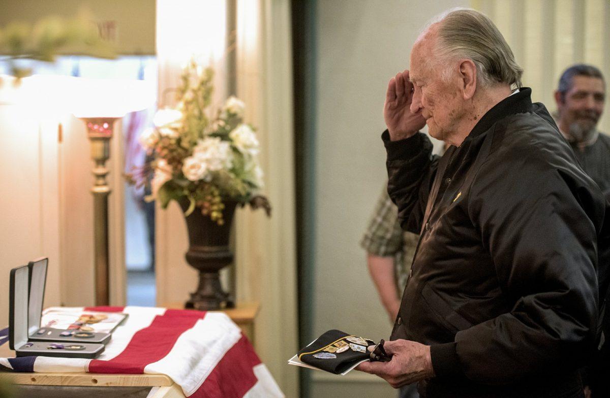 A veteran pays his respects to Army Pvt. William A. Boegli during a funeral service in Bozeman, Mont., on May 25, 2019. (Rachel Leathe/Bozeman Daily Chronicle via AP)