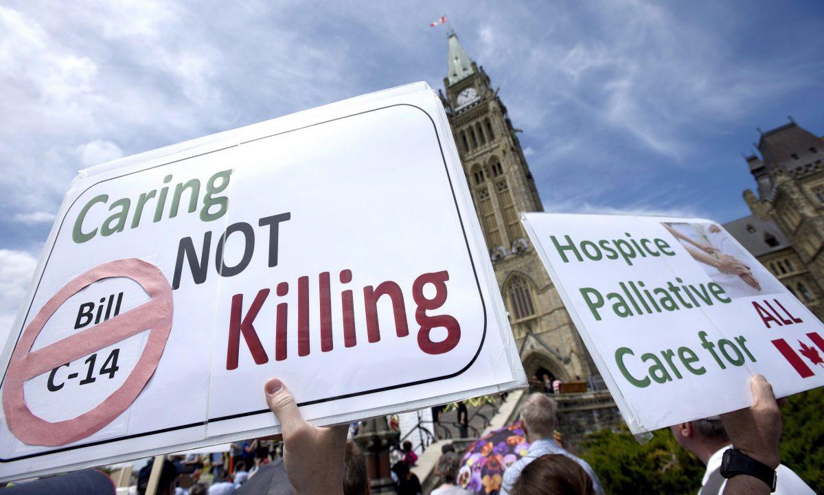 People rally against Bill C-14, the medically assisted dying bill, during a protest organized by the Euthanasia Prevention Coalition on Parliament Hill in Ottawa on June 1, 2016. (The Canadian Press/Justin Tang)
