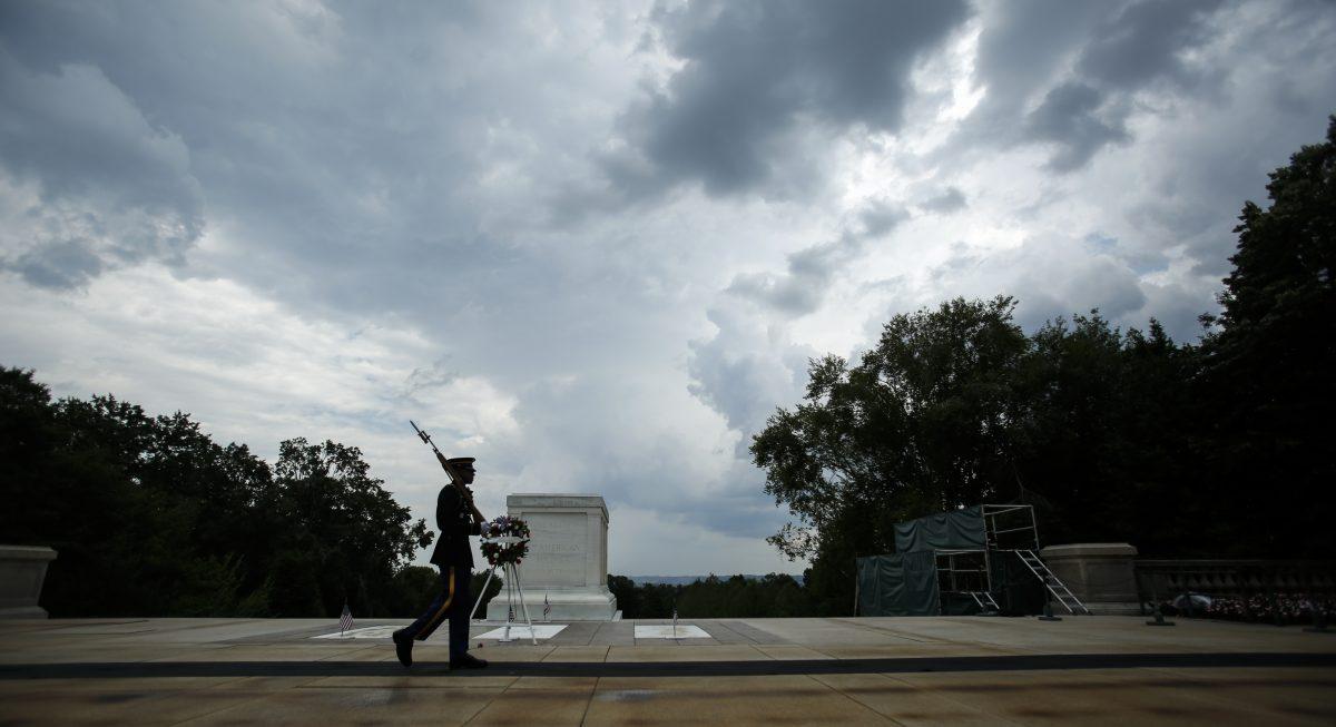 A guard walks pas the Tomb of the Unknown Soldier in Arlington Cemetery in Arlington, Va., on May 26, 2019. (Samira Bouaou/The Epoch Times)