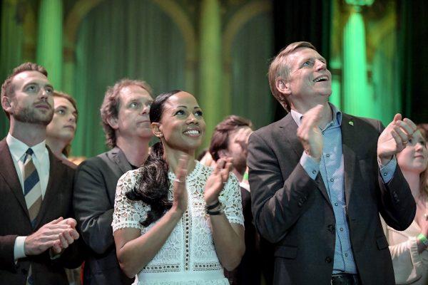 Swedish Green Party candidate Alice Bah Kuhnke (C) and Per Bolund (R), Minister for Financial Markets and Housing, applaud at the party's election night watch party, in Stockholm on May 26, 2019. (Janerik Henriksson/TT News Agency via AP)