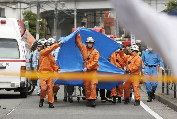 Rescue workers operate at the site where sixteen people were injured in a suspected stabbing by a man, in Kawasaki, Japan on May 28, 2019. (Kyodo/via Reuters)