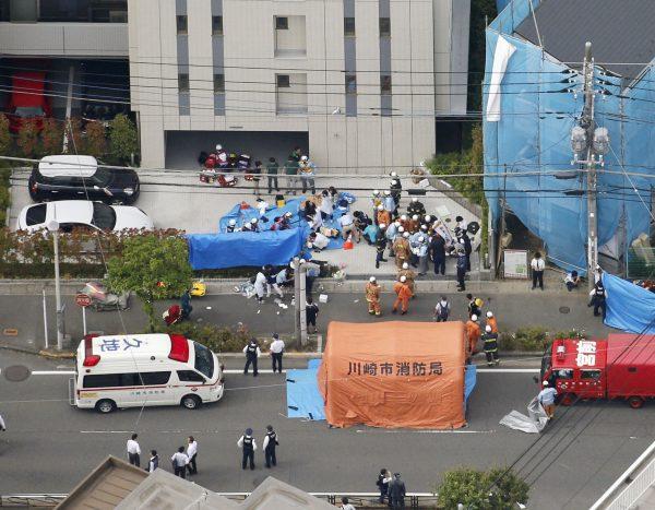 Rescue workers operate at the site where sixteen people were injured in a suspected stabbing by a man, in Kawasaki, Japan, on May 28, 2019. (Kyodo/via REUTERS)