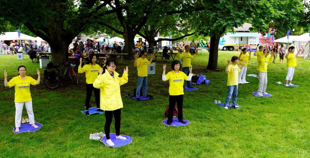 Falun Gong practitioners doing exercise demonstrations in the shade of trees. (Lei Chen)