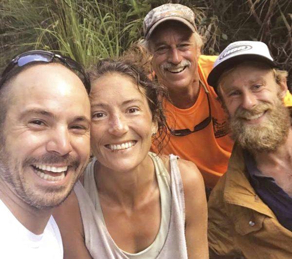 Troy Jeffrey Helmer, resident Amanda Eller, second from left, poses for a photo after being found by searchers, Javier Cantellops, far left, Helmer and Chris Berquist above the Kailua reservoir in East Maui, Hawaii, on May 24, 2019. (Courtesy of Troy Jeffrey Helmer via AP)