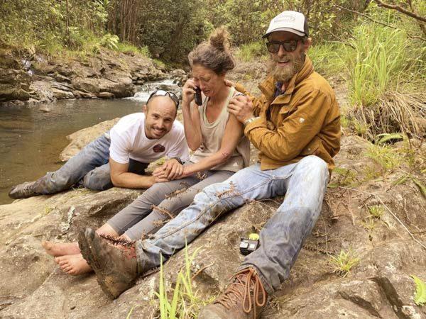 Amanda Eller, second from left, after being found by searchers, Javier Cantellops, far left, and Chris Berquist, right, above the Kailua reservoir in East Maui, Hawaii, on May 24, 2019. (Courtesy of Troy Jeffrey Helmer via AP)