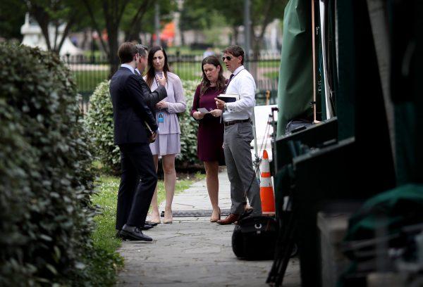 White House press secretary Sarah Sanders confers with staff before answering questions at the White House in Washington on May 29, 2019. (Win McNamee/Getty Images)