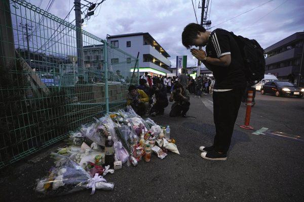 A man pays respects at a makeshift memorial for the victims of a knife attack in Kawasaki, just outside Tokyo on May 28, 2019. (Jae C. Hong/Photo via AP)