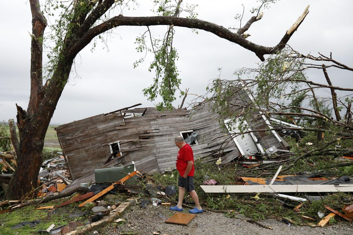 Joe Armison looks over damage to his home after a tornado struck the outskirts of Eudora, Kan., Tuesday, May 28, 2019. (Colin E. Braley/AP