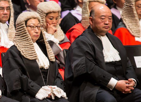 Hong Kong's Chief Justice Geoffrey Ma (R) and Secretary of Justice Teresa Cheng sit during a ceremony held to mark the opening of the legal year in Hong Kong on Jan. 8, 2018. (VIVEK PRAKASH/AFP/Getty Images)